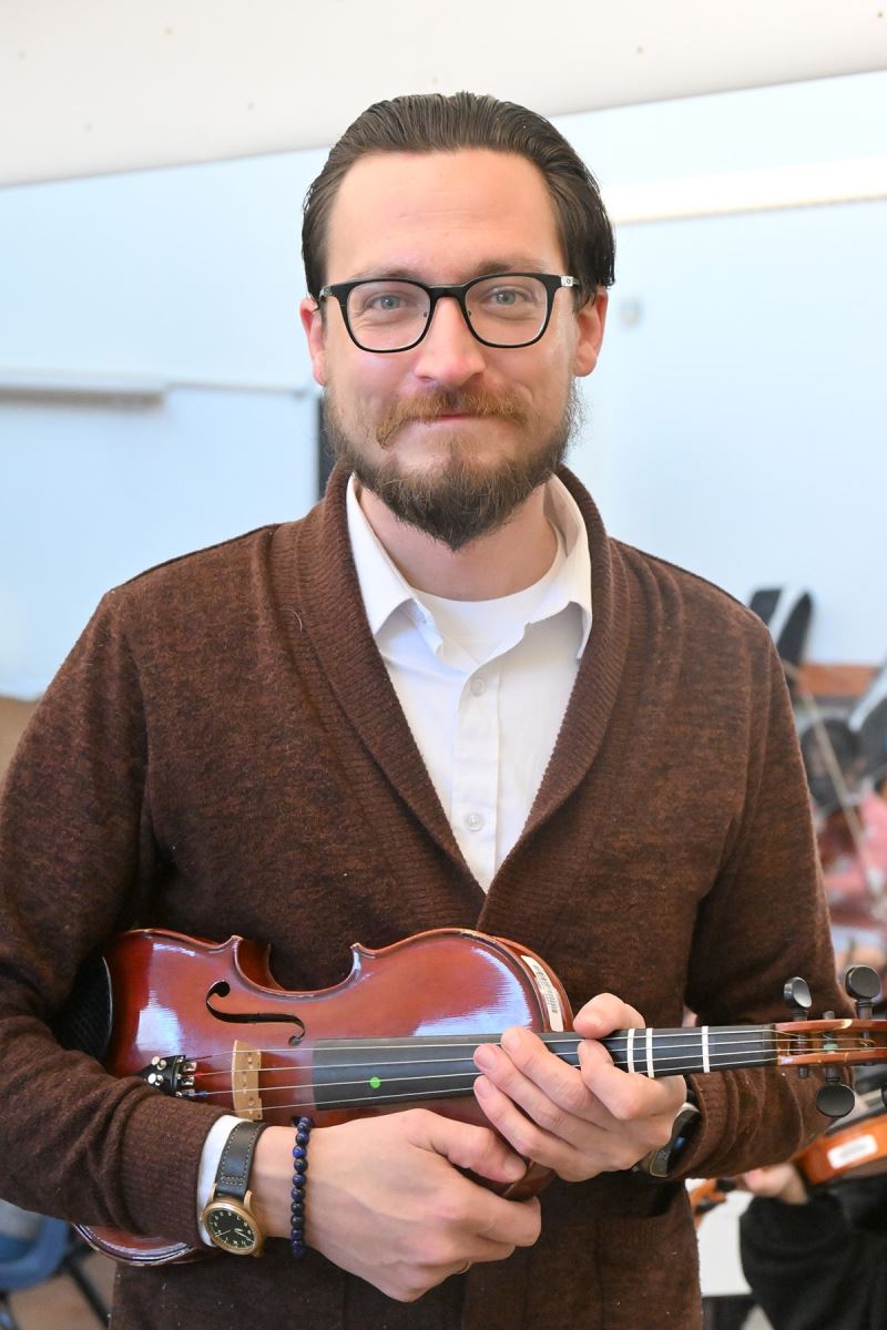 Paul Ensey poses with a violin.